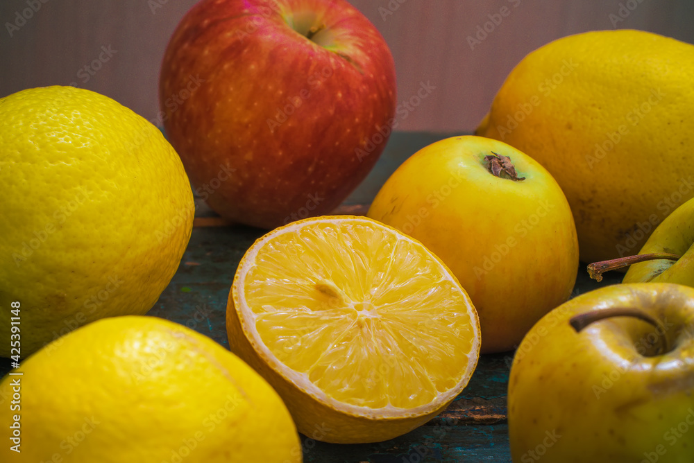 Lemons and apples close-up. Half a lemon. Still life with fruit