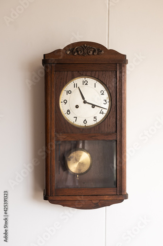 antique clock on a wooden wall