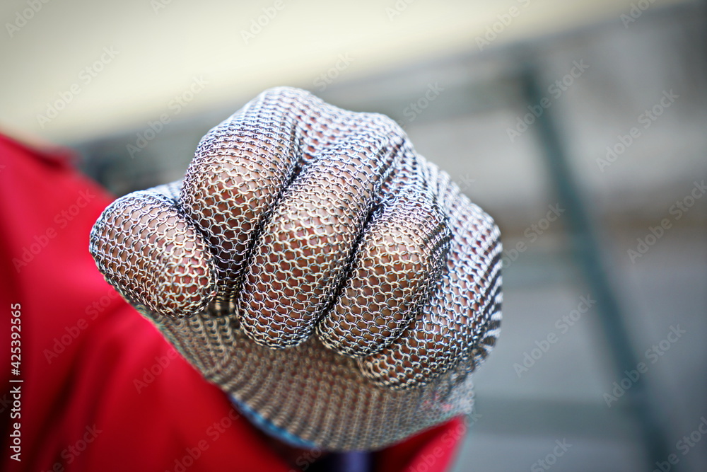 Φωτογραφία Close up on a chain mail butchers protective glove with metal mesh to prevent cuts from knives on the hand