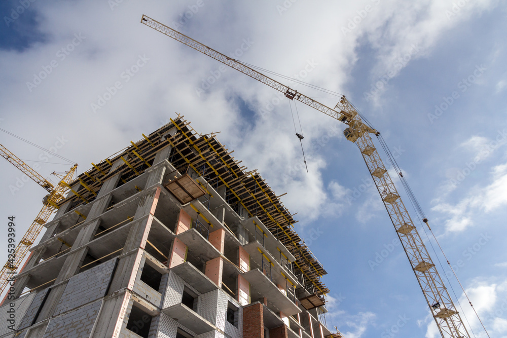 Reinforced concrete construction. Construction yellow crane and building construction. Modern construction technologies