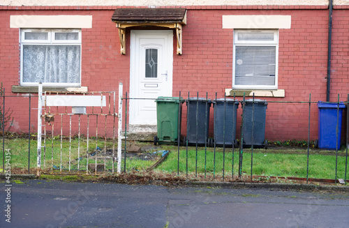 Derelict council house in poor housing estate slum with many social welfare issues in Port Glasgow photo