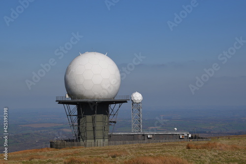 a view of the radar station at Titterstone Clee summit with the sky clear blue