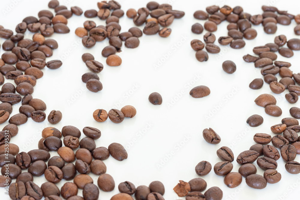 Top view of coffee beans isolated on a white background with copy space Top view of coffee beans isolated on a white background with copy space