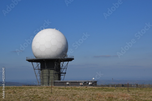 a view of the radar station at Titterstone Clee summit with the sky clear blue