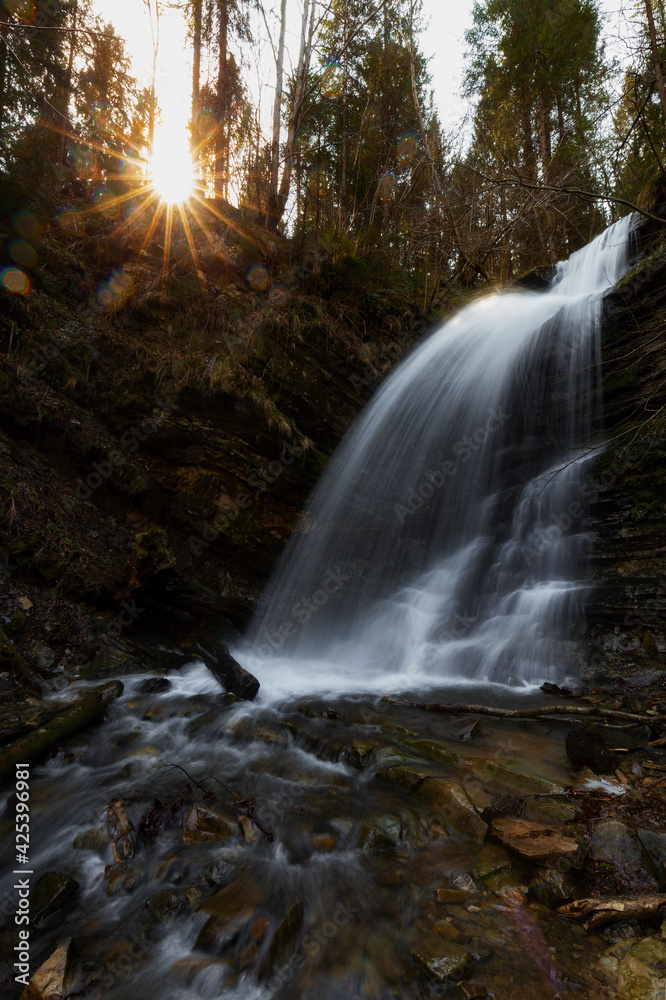 Obraz premium Amazing nature landscape, mountain waterfall, natural background suitable for wallpaper, Carpathian mountains. Waterfall in the backlight. Lazny waterfall, Lviv region, Ukraine. Carpathian river.