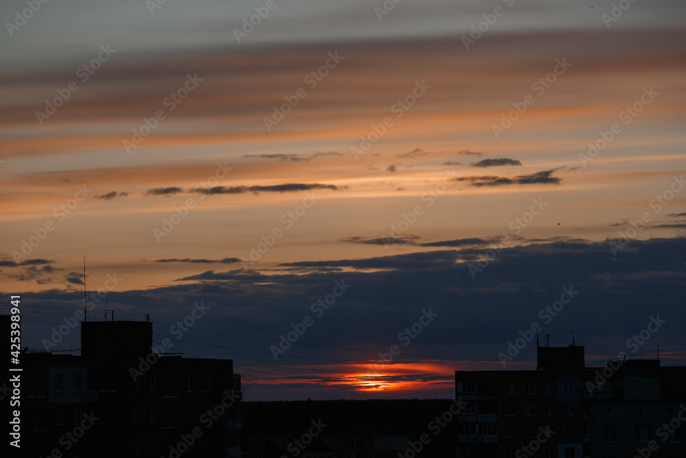 Sunset sky against the background of city houses.