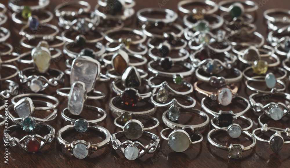 Set of silver rings on a wooden table Set of silver rings on a wooden table