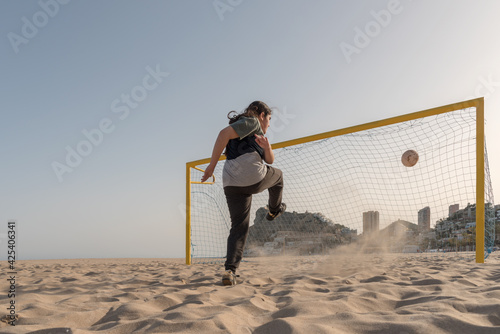 Ball arriving at the goal after being shot by a teenager.