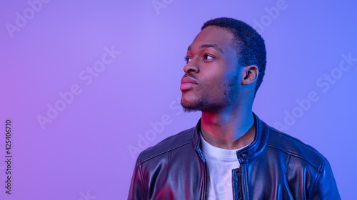 Portrait Of Stylish African American Guy In Leather Jacket Under Neon Light