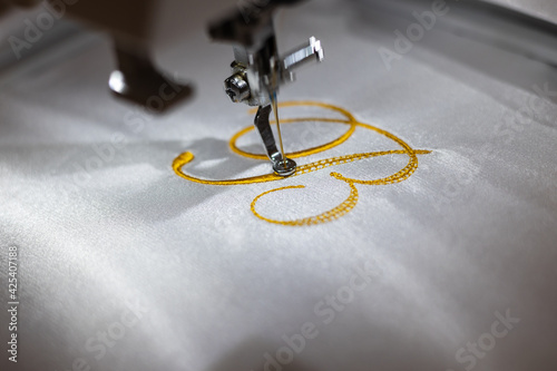 Machine embroider the inscription 