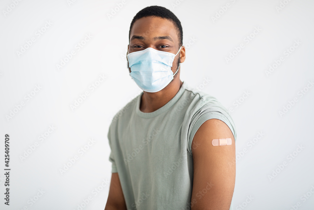 Portrait Of Vaccinated African Guy Wearing Face Mask, White Background Portrait Of Vaccinated African Guy Wearing Face Mask, White Background