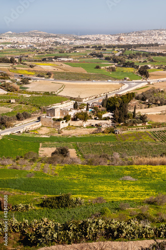 Aerial view on grounds around Mdina, old capital of Malta island. Panorama of agricultural fields. Cityscape.and urban roads.