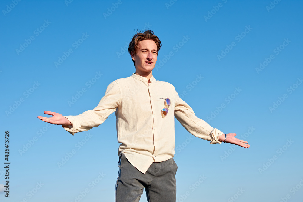 A Caucasian man from Spain acting confused and surprised on clear sky background A Caucasian man from Spain acting confused and surprised on clear sky background