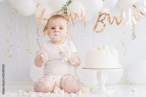 baby boy eating birthday cake