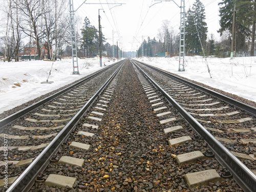 railway tracks go off into the distance in the spring
