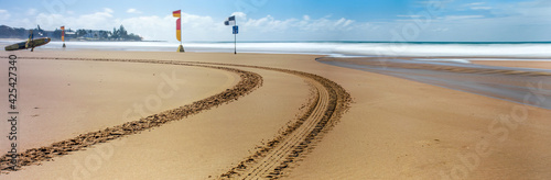 Tyre tracks on the beach leading to the life savers
