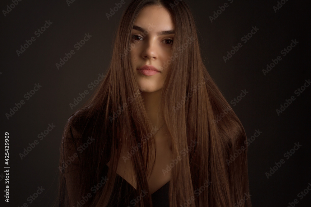 portrait of a young woman with long brown hair.