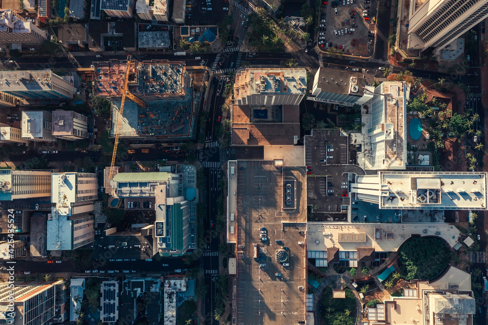 Aerial top down view of main street in downtown Waikiki, Honolulu. Urban construction area, Oahu Island