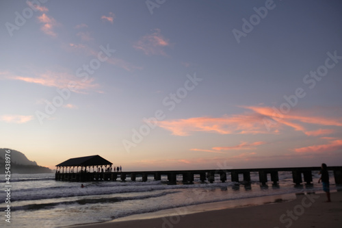 The Hanalei Pier glows in the sunset
