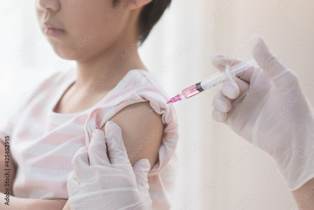 Asian child receiving injection or vaccine Asian child receiving injection or vaccine