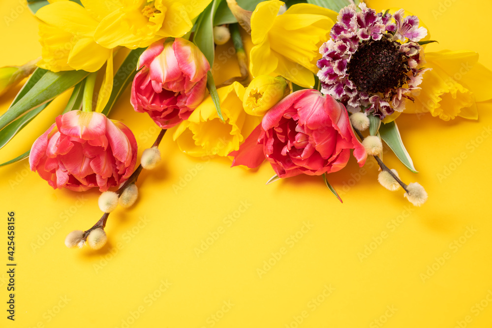 Vibrant spring flowers on yellow background