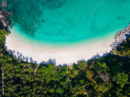 Aerial view nature summer sea waves in top-down drone shot perspective. Crashing wave line in Phuket South of Thailand. Andaman sea with foamy white texture.