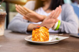 Blur of hands woman refusing cake or junk food in restaurant,No meal,Diet food concept