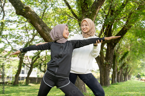happy muslim with exercising partner doing sport together outdoor