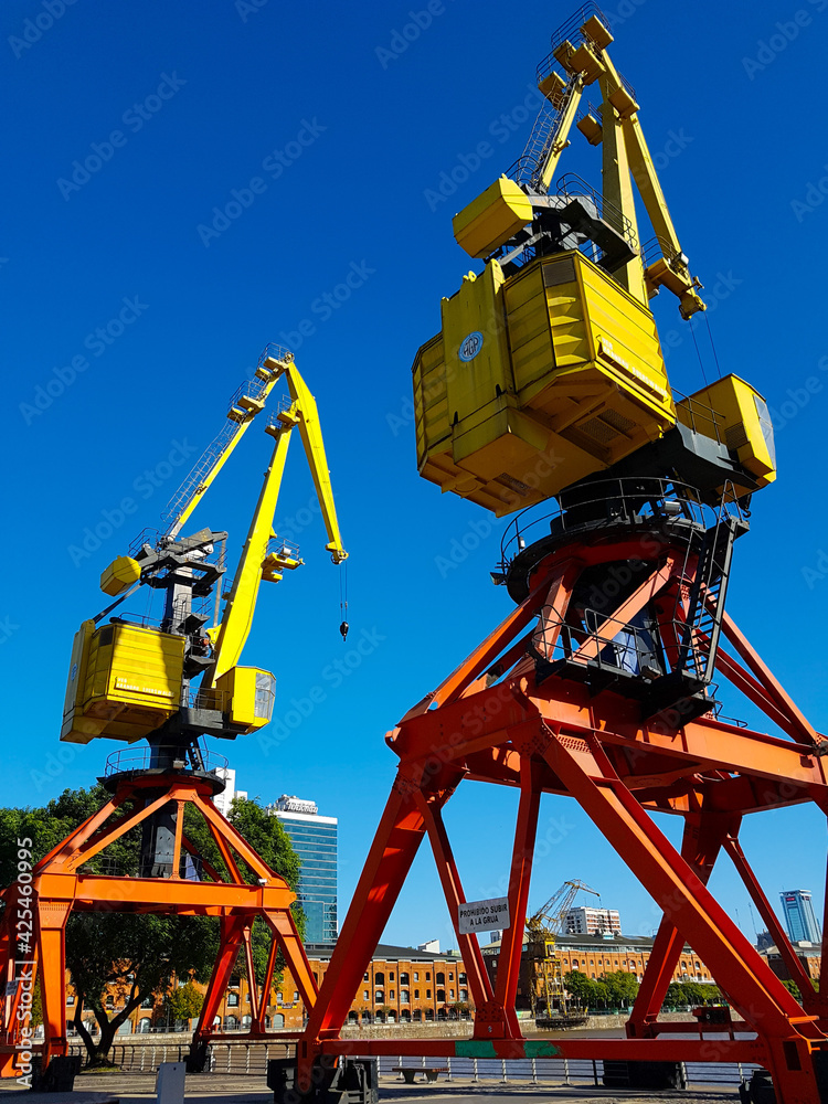 Colorful old cranes against a very blue sky