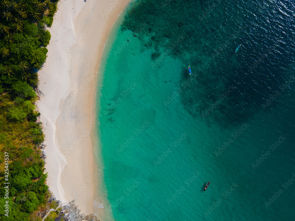 Aerial view nature summer sea waves in top-down drone shot perspective. Crashing wave line in Phuket South of Thailand. Andaman sea with foamy white texture.