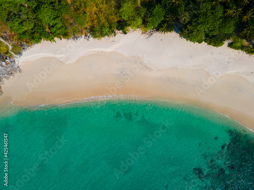 Aerial view nature summer sea waves in top-down drone shot perspective. Crashing wave line in Phuket South of Thailand. Andaman sea with foamy white texture.