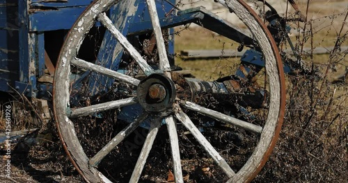 Patinaed old wooden farm wagon sitting in the middle of the tall grass at the Moore Farm Museum in Gatineau, Quebec. photo