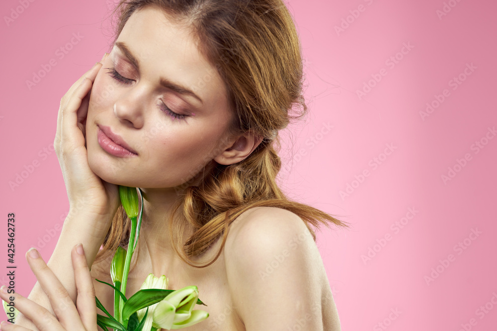 Portrait of woman with white flowers beautiful face pink background naked shoulders Portrait of woman with white flowers beautiful face pink background naked shoulders