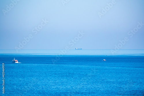 Several ships in the blue calm sea. © Dmitrii Potashkin