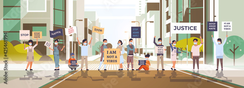 stop asian hate people in masks holding banners against racism support people during coronavirus pandemic