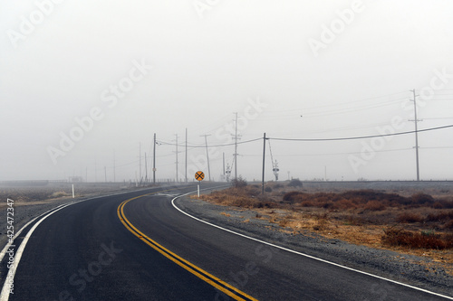 landscape shot of an empty road in fog © Andrew