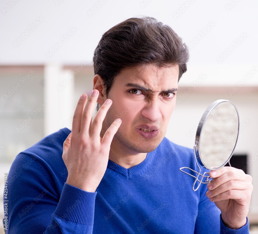 Man panicking because of pimples on the skin Man panicking because of pimples on the skin