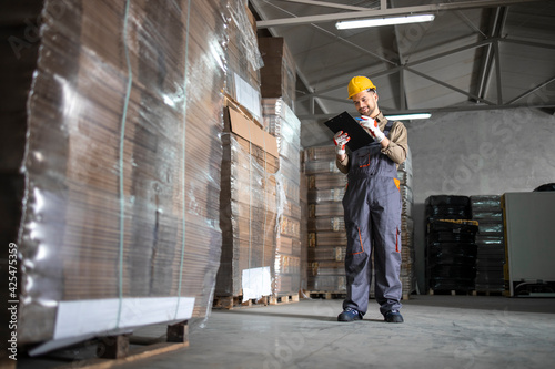 Wallpaper Mural Warehouse worker checking inventory in storehouse storage department. Torontodigital.ca