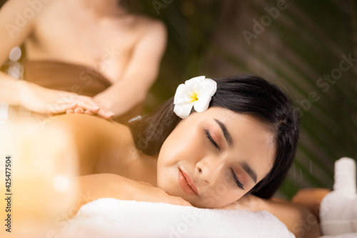 beauty, spa, resort and relaxation concept - beautiful woman in spa salon