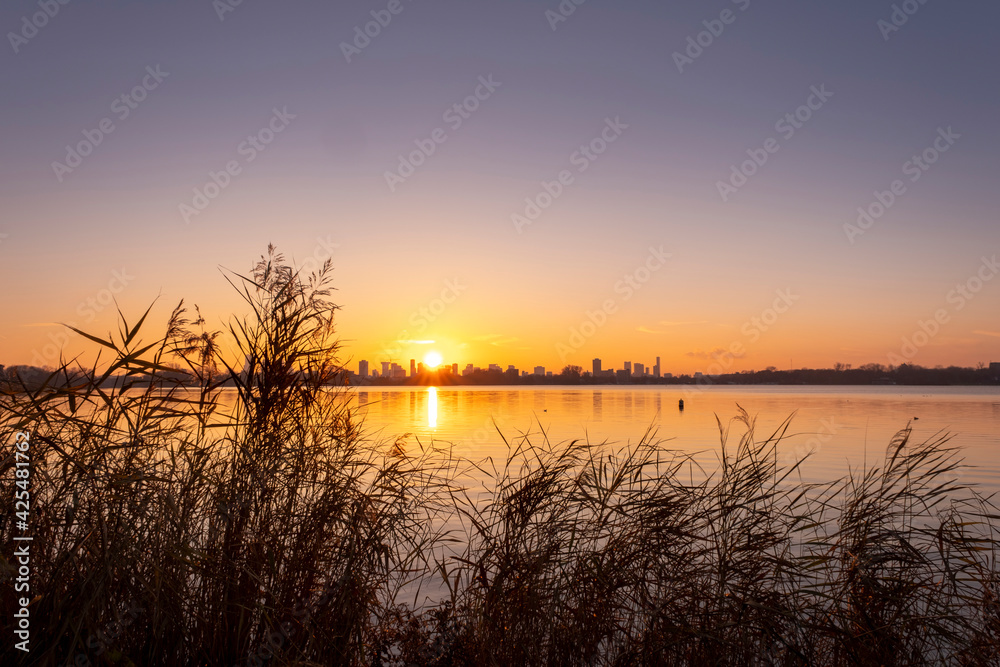 Obraz premium Sunset over lake Kralingse Plas in Rotterdam, the Netherlands, as seen from the promenade on the eastern shore