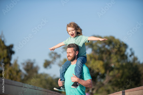 Father and son outside. People having fun outdoors. Concept of happy vacation and friendly family.