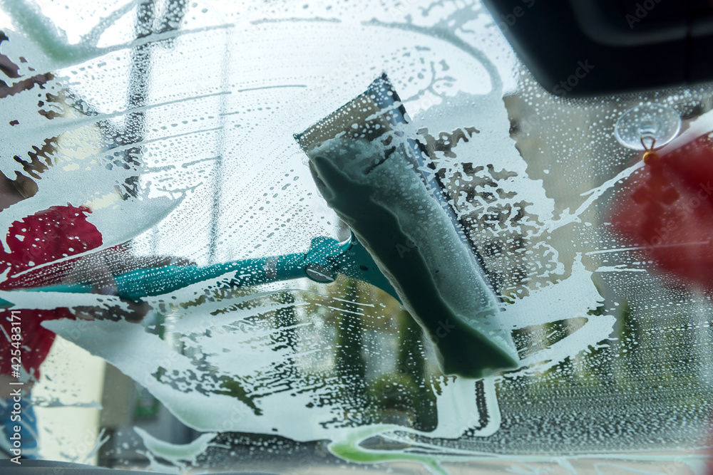 Closeup of hand use green sponge with foam washing car - obrazy, fototapety, plakaty 