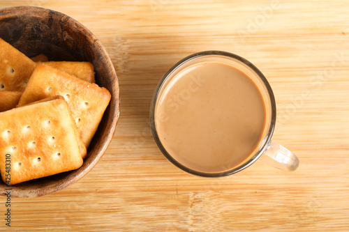 Morning breakfast concept. tea cup and Biscuit on wooden background.