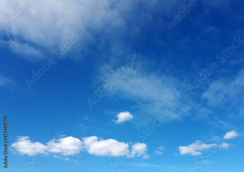 Blue sky background with fluffy white clouds