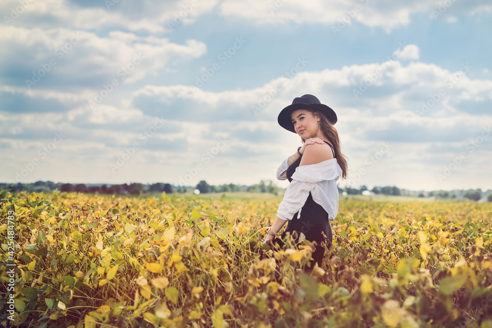Beautiful young lady in rural field in summer day Beautiful young lady in rural field in summer day
