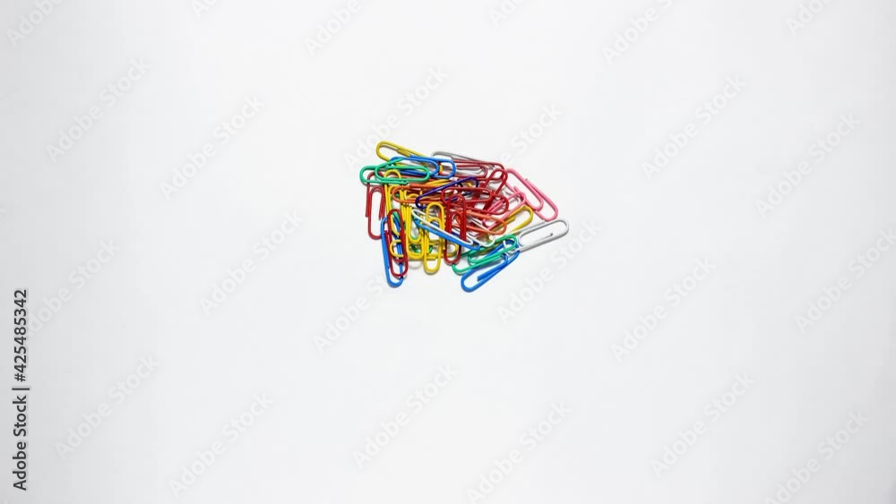 Stop motion animation. Stationery colored paper clips that move on a ...