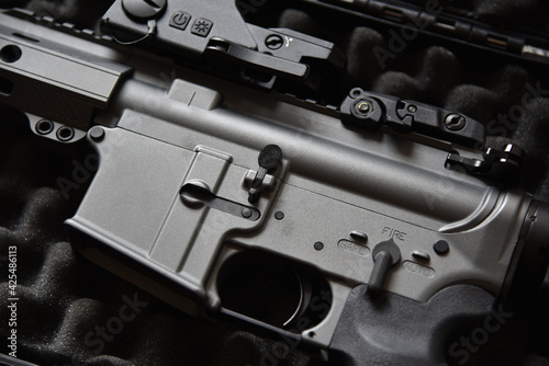 Close-up of a M4A1 (AR-15 model) weapons and military equipment for army, Assault rifle gun on a black case box.