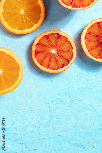 Fresh juicy oranges  shot from above on a blue background