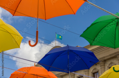 Colored umbrella on the street. The flag of Kazakhstan can be seen among the umbrellas. Street decoration with umbrellas. photo