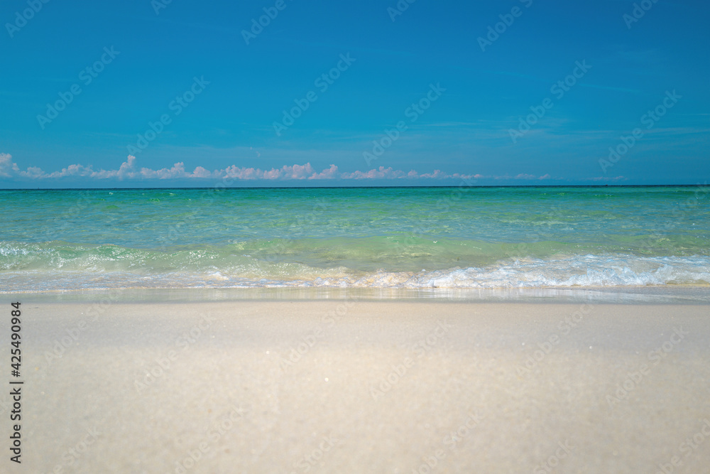 Ocean blue Background. Soft blue ocean wave on sandy beach. Beautiful beach with blue sea water.